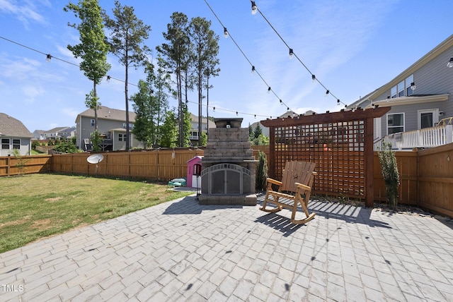 view of patio / terrace with an outdoor fireplace, a residential view, and a fenced backyard