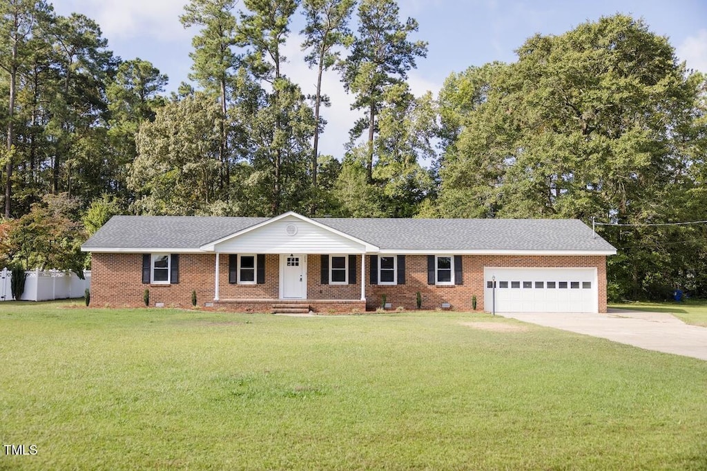 ranch-style home with a porch, a garage, and a front lawn