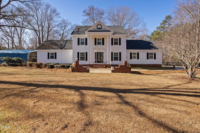 view of front facade featuring a front yard and a carport