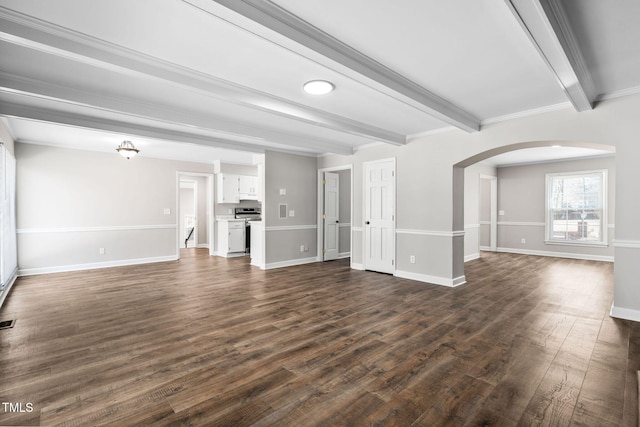 unfurnished living room featuring dark hardwood / wood-style flooring, beamed ceiling, and ornamental molding