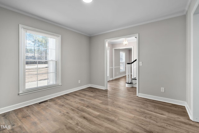 unfurnished room featuring hardwood / wood-style flooring and ornamental molding