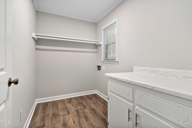 laundry room with crown molding, hookup for a washing machine, cabinets, and dark hardwood / wood-style floors