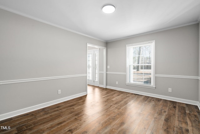 empty room featuring dark hardwood / wood-style floors and ornamental molding