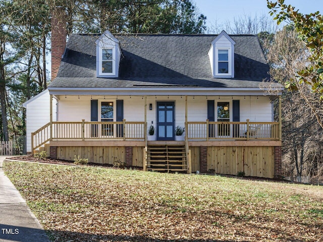 cape cod-style house with covered porch