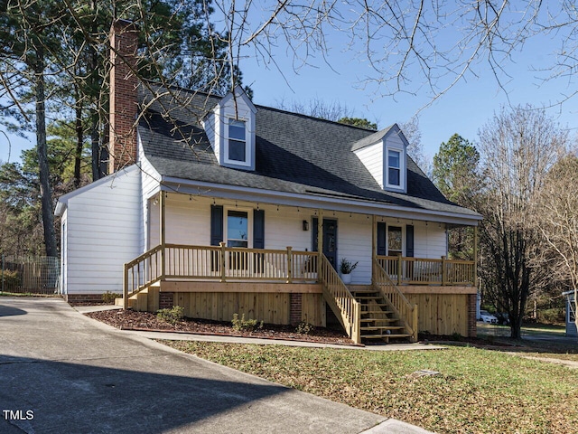 cape cod-style house featuring covered porch