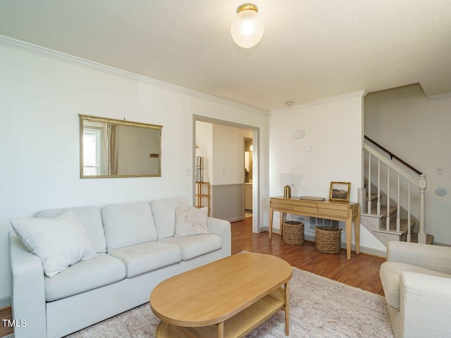 living room with hardwood / wood-style floors and ornamental molding