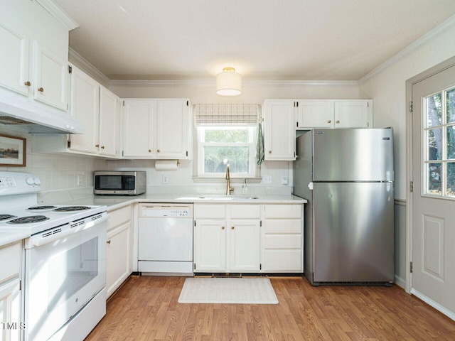 kitchen with appliances with stainless steel finishes, white cabinetry, and sink