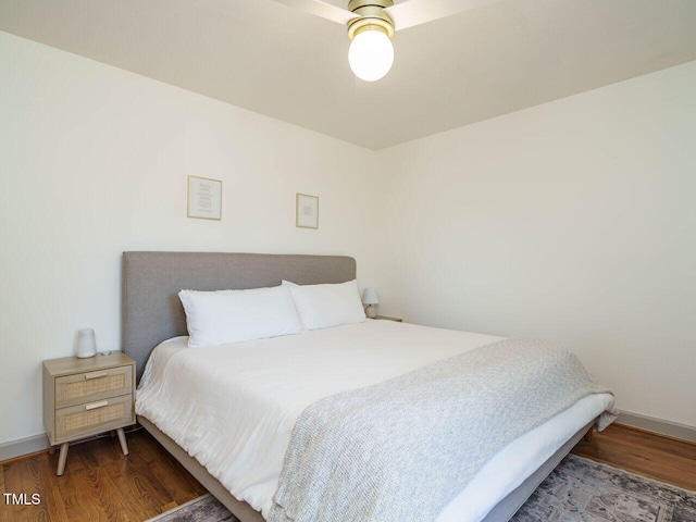 bedroom featuring dark wood-type flooring and ceiling fan