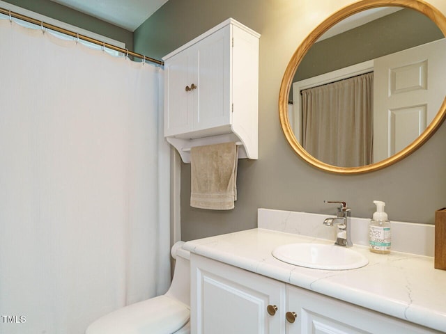 bathroom with toilet and vanity