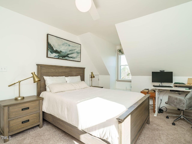 bedroom with lofted ceiling, ceiling fan, and light carpet