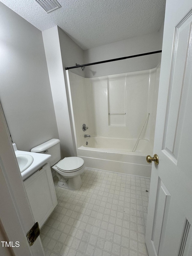 full bathroom featuring vanity, toilet, bathing tub / shower combination, and a textured ceiling