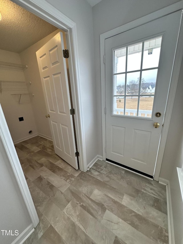 doorway featuring a textured ceiling