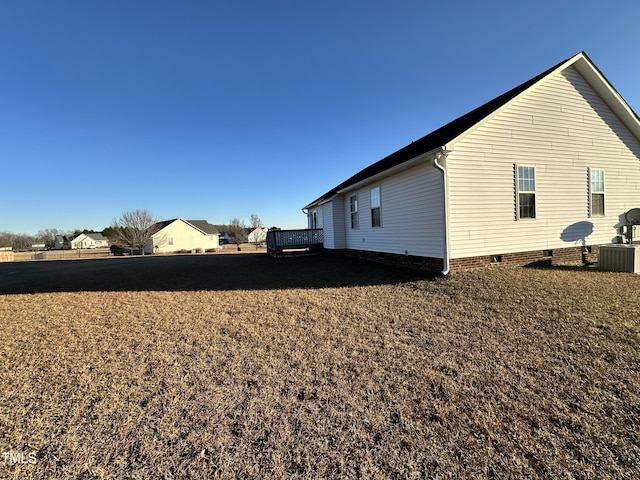 view of home's exterior with a deck and central AC unit