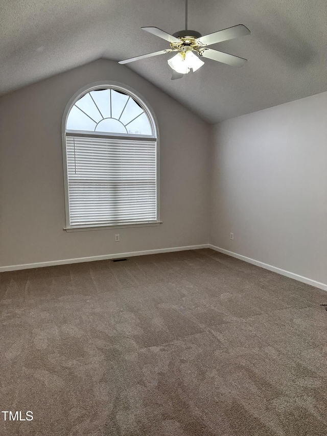 unfurnished room with lofted ceiling, carpet floors, a textured ceiling, and ceiling fan