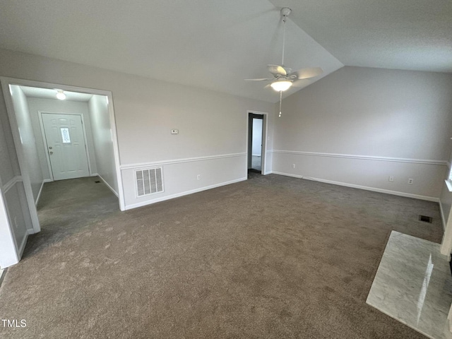 unfurnished living room featuring ceiling fan, lofted ceiling, and dark carpet