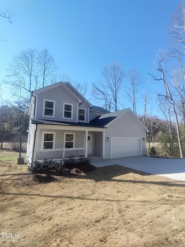 view of front of home featuring a garage, concrete driveway, and covered porch