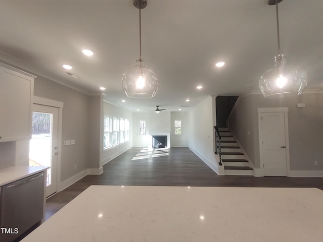 interior space featuring dark wood-style flooring, a fireplace, recessed lighting, baseboards, and stairs