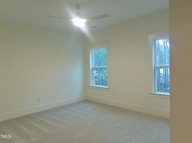 unfurnished room with a ceiling fan and baseboards