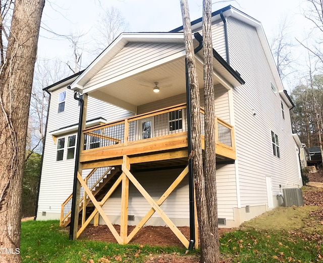 rear view of property with a deck, central air condition unit, a ceiling fan, stairs, and crawl space