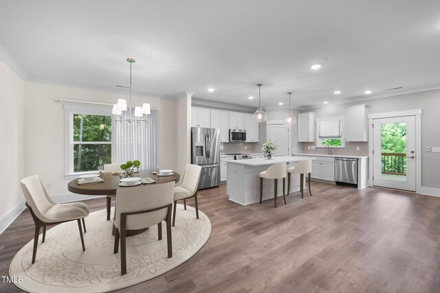 632 Angus Ct, Sanford, NC 27332 - dining area featuring a chandelier, recessed lighting, baseboards, crown molding, and wood finished floors