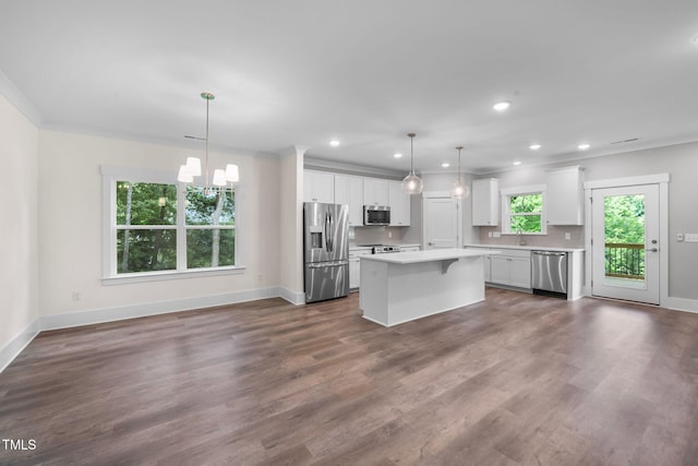 632 Angus Ct, Sanford, NC 27332 - kitchen featuring appliances with stainless steel finishes, light countertops, a chandelier, baseboards, and white cabinets