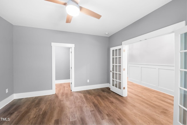 632 Angus Ct, Sanford, NC 27332 - spare room featuring a ceiling fan, french doors, wood finished floors, baseboards, and a wainscoted wall