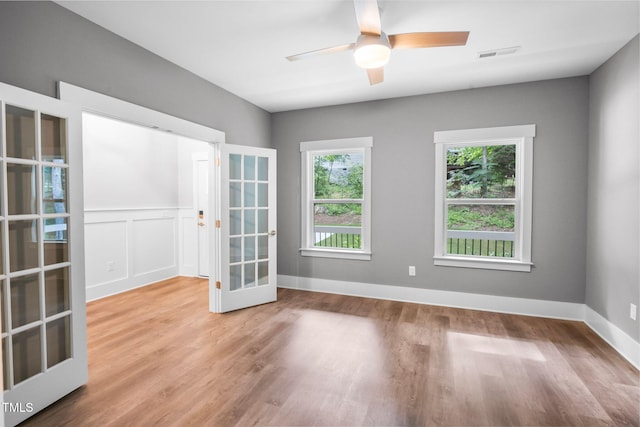 632 Angus Ct, Sanford, NC 27332 - empty room with wood finished floors, ceiling fan, and french doors