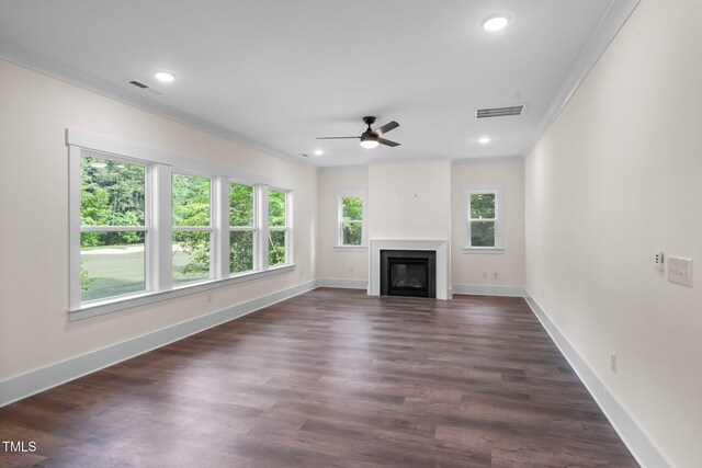 632 Angus Ct, Sanford, NC 27332 - unfurnished living room featuring a ceiling fan, crown molding, a glass covered fireplace, baseboards, and recessed lighting