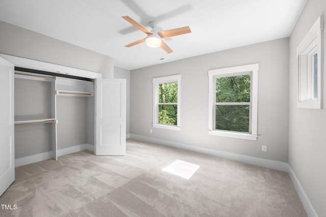 632 Angus Ct, Sanford, NC 27332 - unfurnished bedroom featuring light carpet, baseboards, a closet, and a ceiling fan