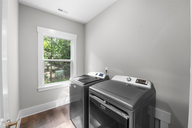 632 Angus Ct, Sanford, NC 27332 - laundry room with separate washer and dryer, plenty of natural light, wood finished floors, and baseboards