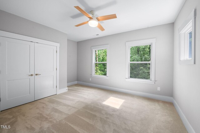 632 Angus Ct, Sanford, NC 27332 - unfurnished bedroom featuring carpet, baseboards, a closet, and ceiling fan