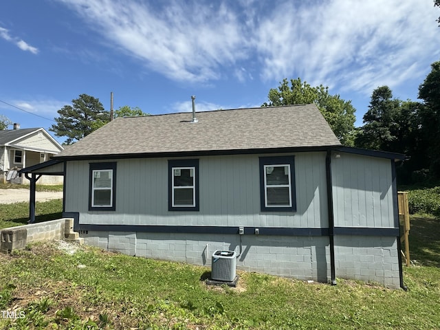 view of home's exterior with a yard and central air condition unit