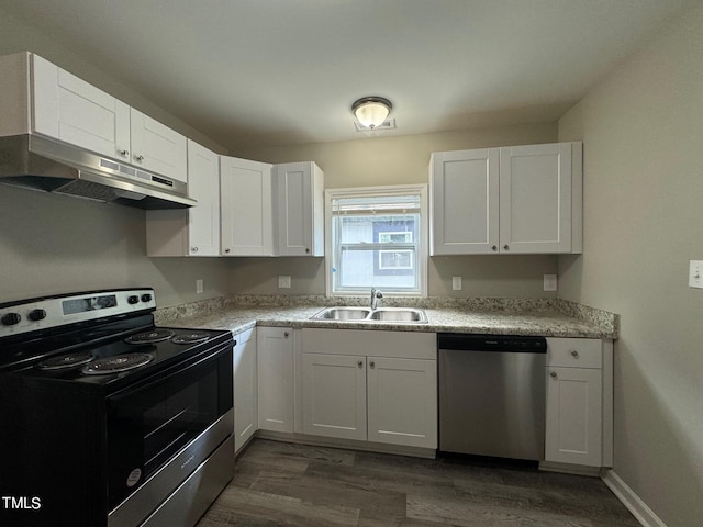 kitchen with dark wood-type flooring, sink, white cabinets, and stainless steel appliances