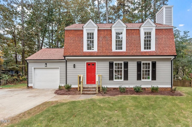 view of front of home with a front yard and a garage