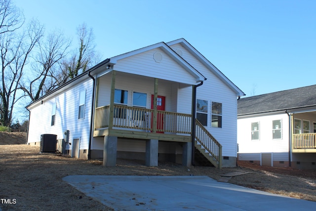 view of front of house with a porch and central air condition unit