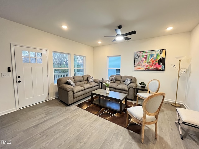 living room with wood-type flooring and ceiling fan