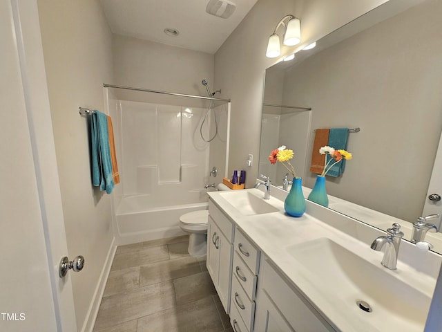 full bathroom featuring shower / washtub combination, vanity, and toilet