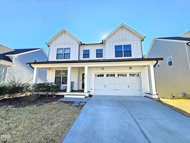 modern farmhouse with driveway, an attached garage, a porch, and board and batten siding