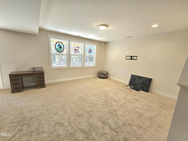 unfurnished room featuring light carpet