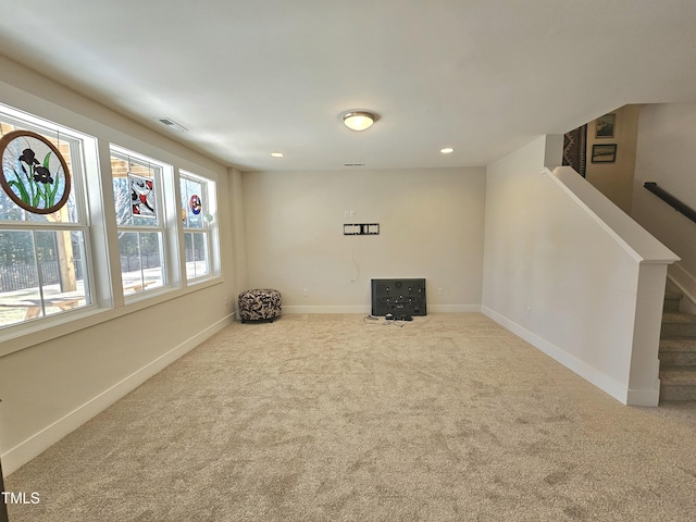 unfurnished room featuring light carpet