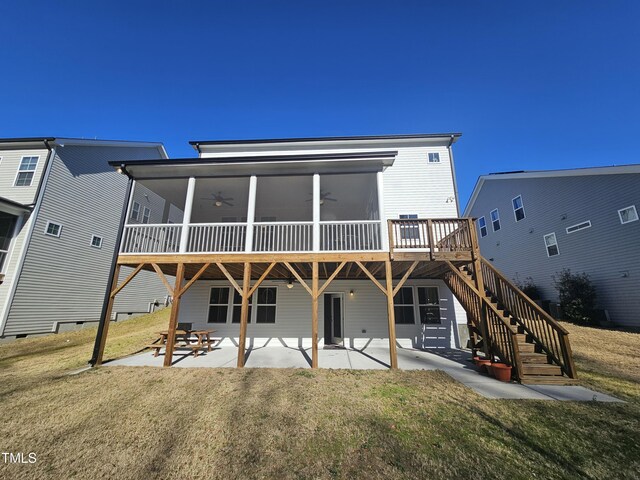 back of property with a ceiling fan, a patio, a lawn, and stairs