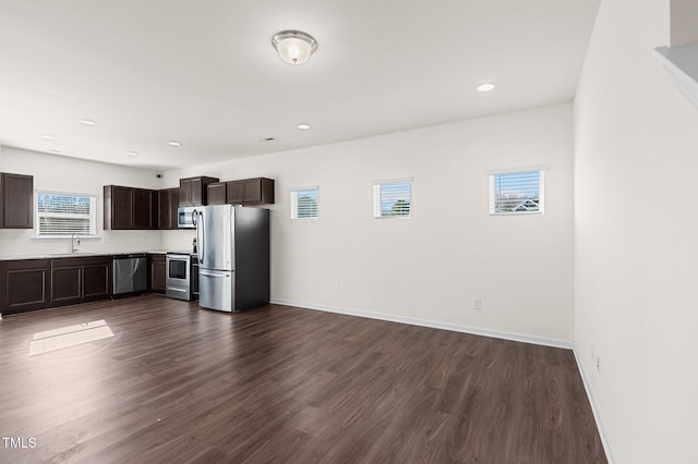 kitchen featuring dark hardwood / wood-style flooring, dark brown cabinetry, and stainless steel appliances