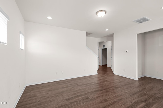 spare room with dark wood-type flooring