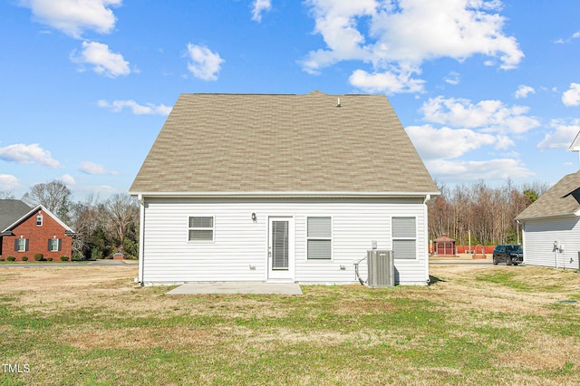 back of house featuring a lawn, a patio area, and central air condition unit