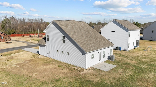 rear view of property featuring central air condition unit, a yard, and a patio