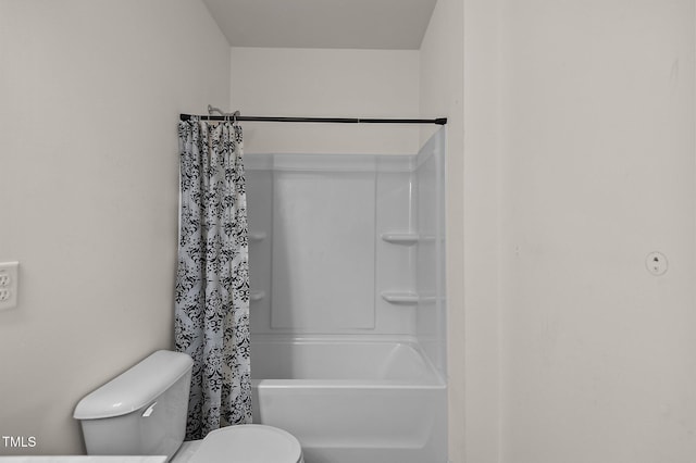 bathroom with toilet and shower / bath combo with shower curtain