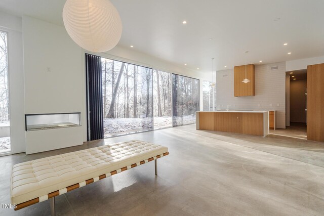 unfurnished living room with a wall of windows