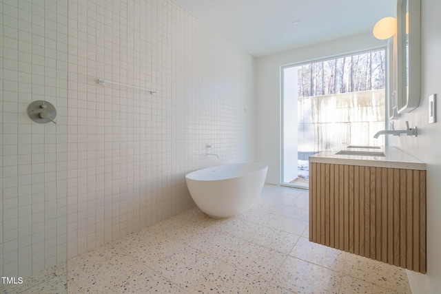 bathroom with plus walk in shower and tile walls