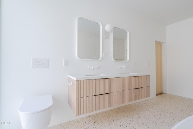 bathroom featuring vanity and toilet