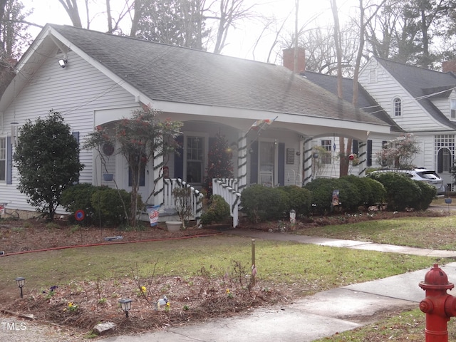 view of front of property with a front yard and covered porch